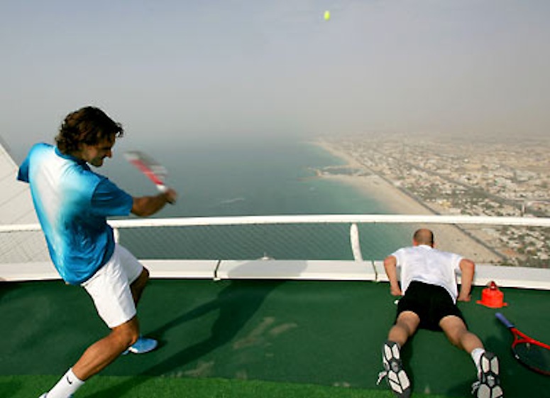 Federer and Agassi on a tennis court on a roof in Dubai