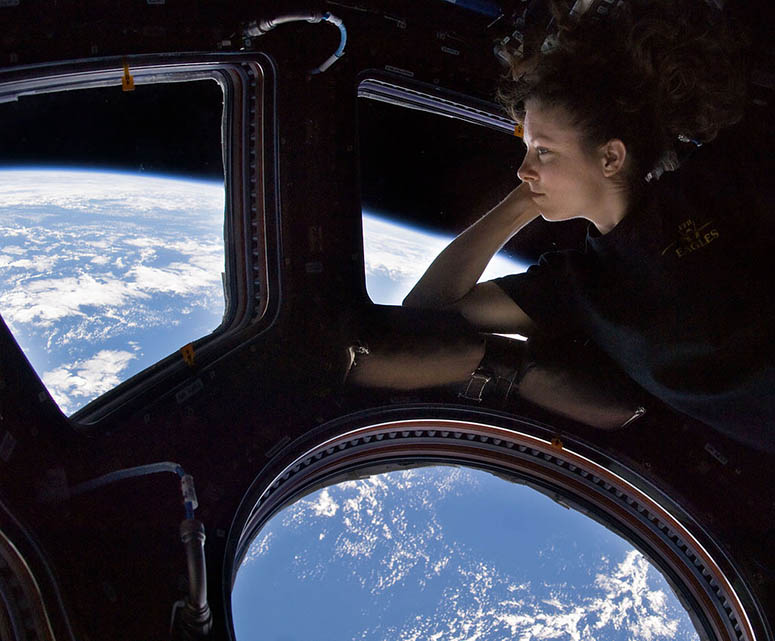 Astronaut Tracy Caldwell Dyson by the windows in the Cupola on ISS